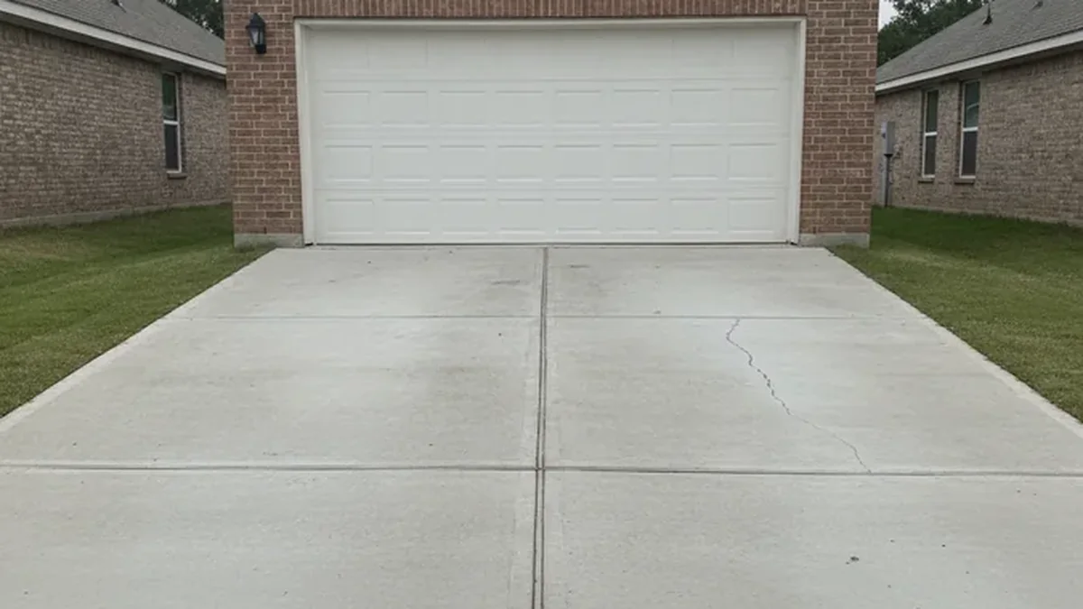 A concrete driveway with a cracked panel at a Forney, Texas home before an estimate.