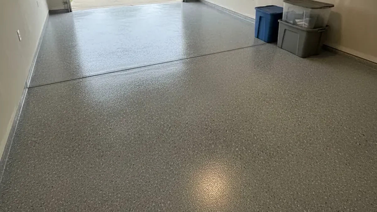 A finished garage floor coating creates a clean surface around parked vehicles and storage.